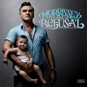 Morrissey holds a baby